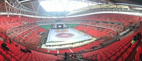 Narendra Modi UK visit 2015: Pics of electric atmosphere at Wembley Stadium for 'UKWelcomesModi' community reception The elaborate and colourful Rangoli creation in the middle of Wembley stadium as part of giving Modi an Indian welcome in the UK. Also, enthusiastic UK Indians already taking seats ready for the event to start